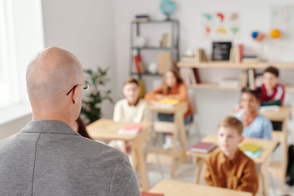 Teacher leading a classroom discussion with attentive students, focusing on learning and engagement