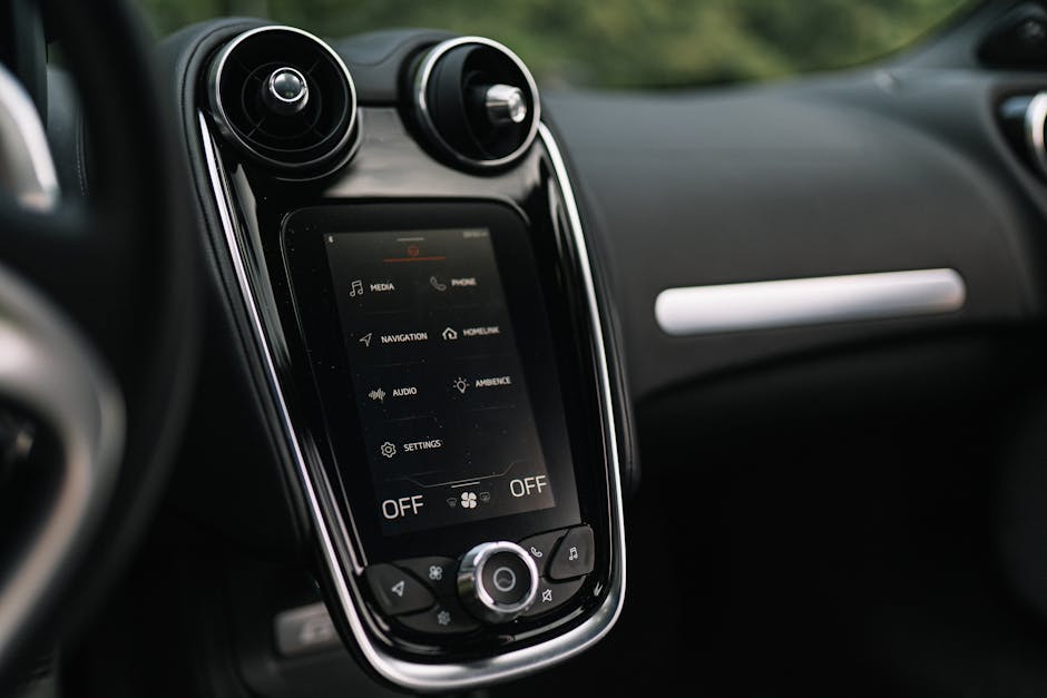 Close-up of a sleek car dashboard featuring a modern touchscreen interface